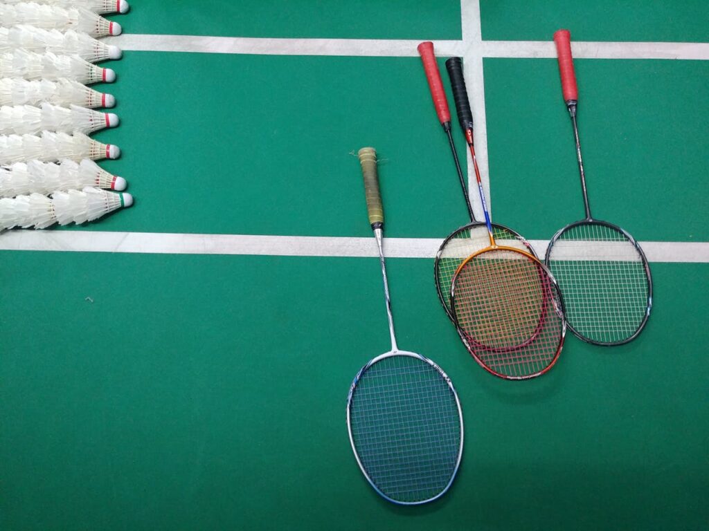 Green and White Court with Badminton Rackets